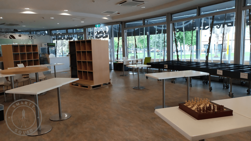 room with empty shelves and tables