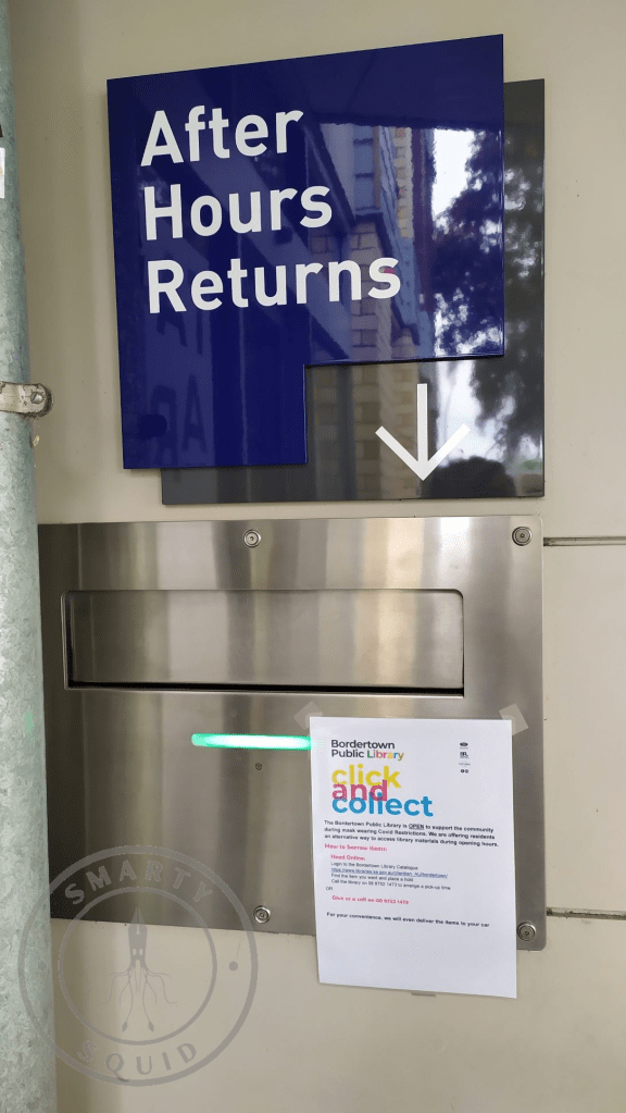 metal book returns chute with a blue sign above saying After Hours Returns